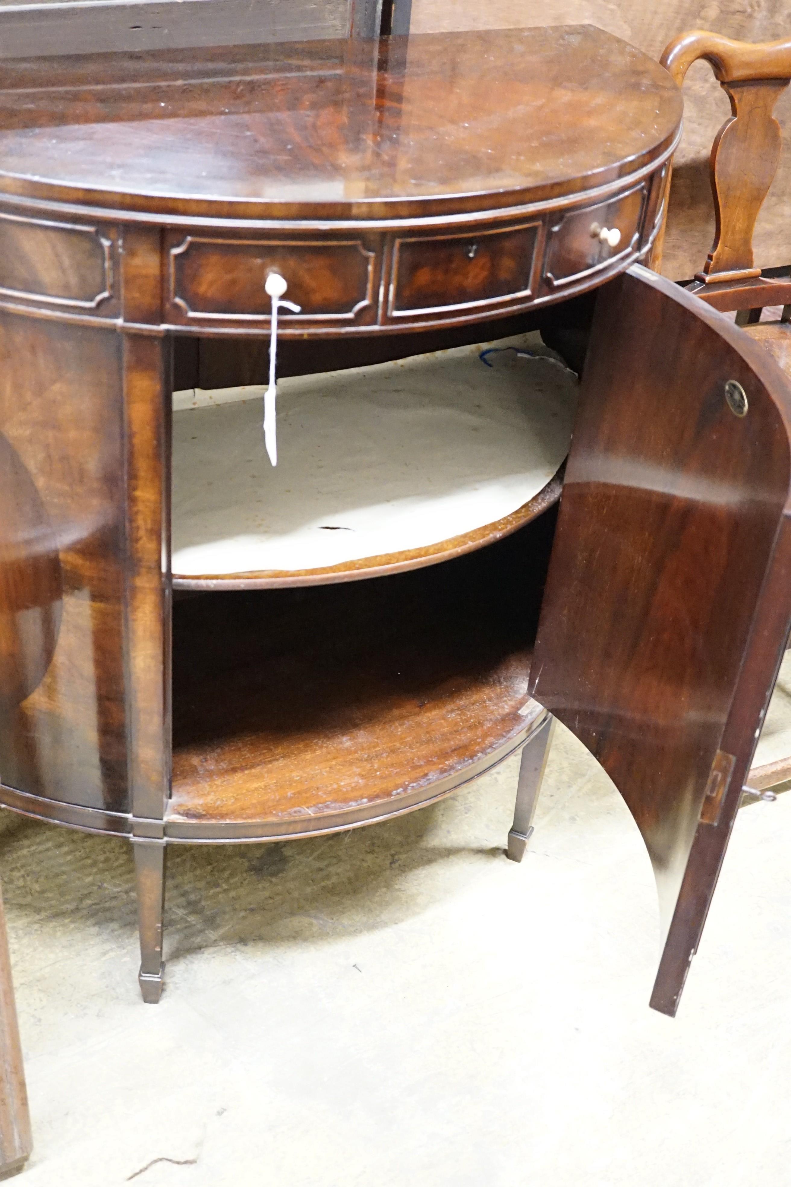 An early 20th century Maple & Co. mahogany demi-lune side cabinet with frieze drawer, width 84cm, height 84cm